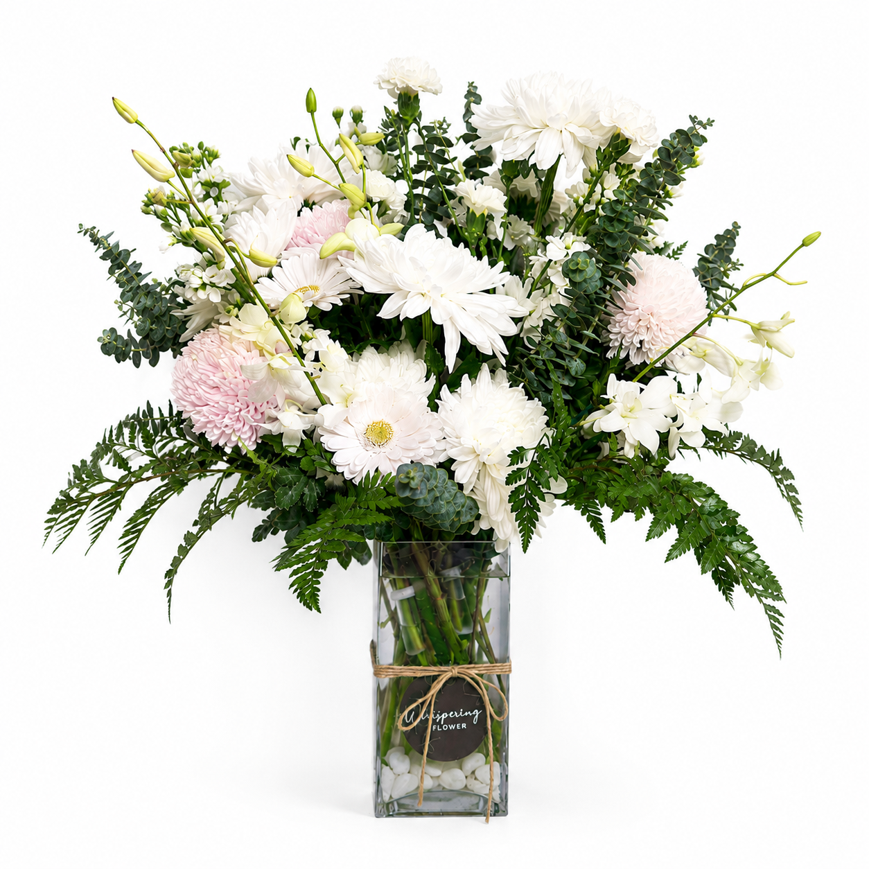 Bouquet of white and pink flowers in a clear vase on a white background