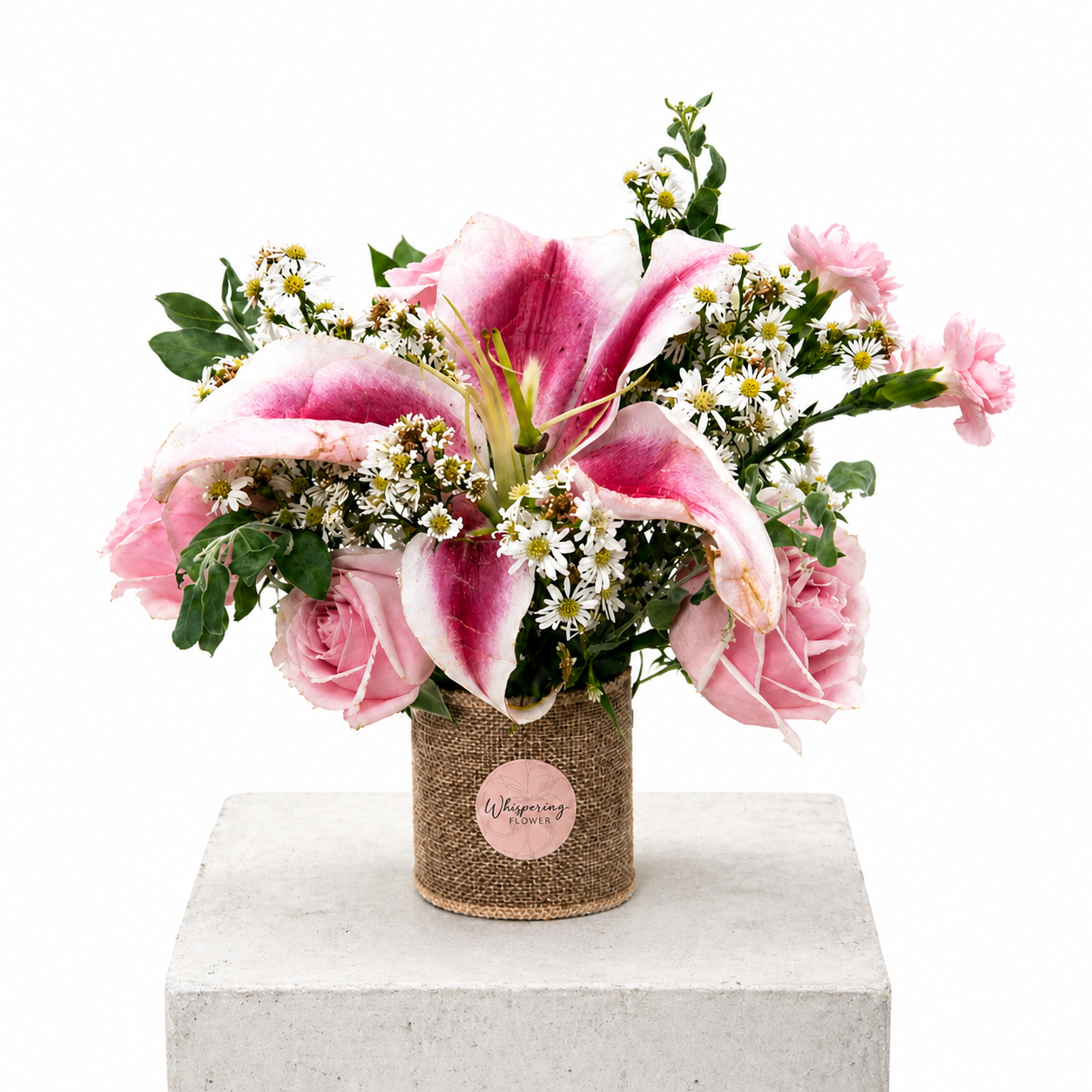 Mum's Little Garden bouquet — stargazer lilies, pink gerberas, white roses, and seasonal blooms hand-arranged in a kraft container. Mother's Day Auckland delivery.