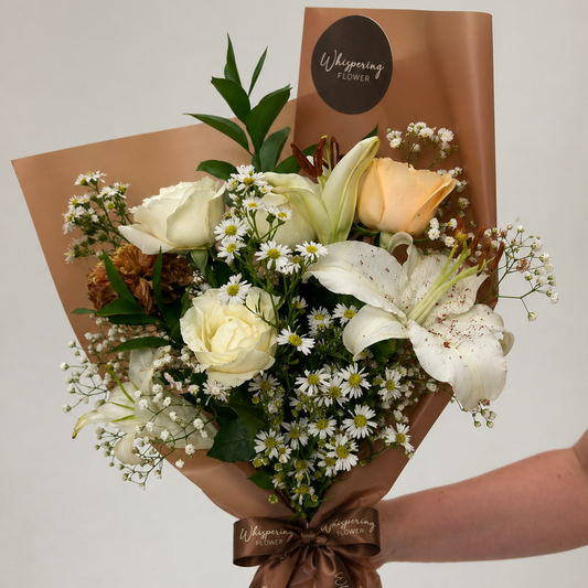 Mum's Signature Bloom — premium Mother's Day bouquet with white roses, stargazer lilies, and gypsophila wrapped in kraft paper. Hand-wrapped in Mount Wellington and delivered across Auckland.