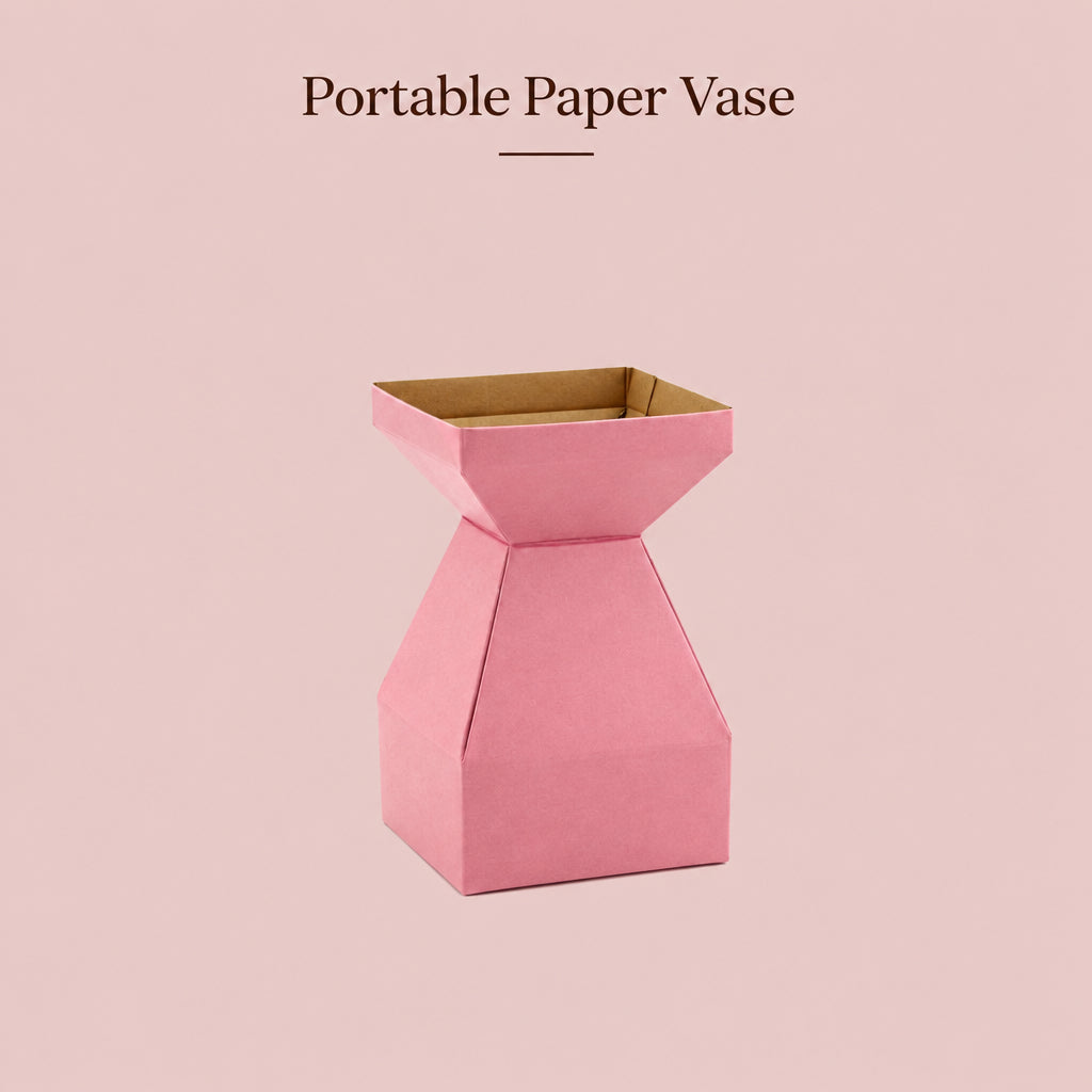 A pink portable paper vase made from folded cardboard, shown on a solid pink background with the text 'Portable Paper Vase' at the top.